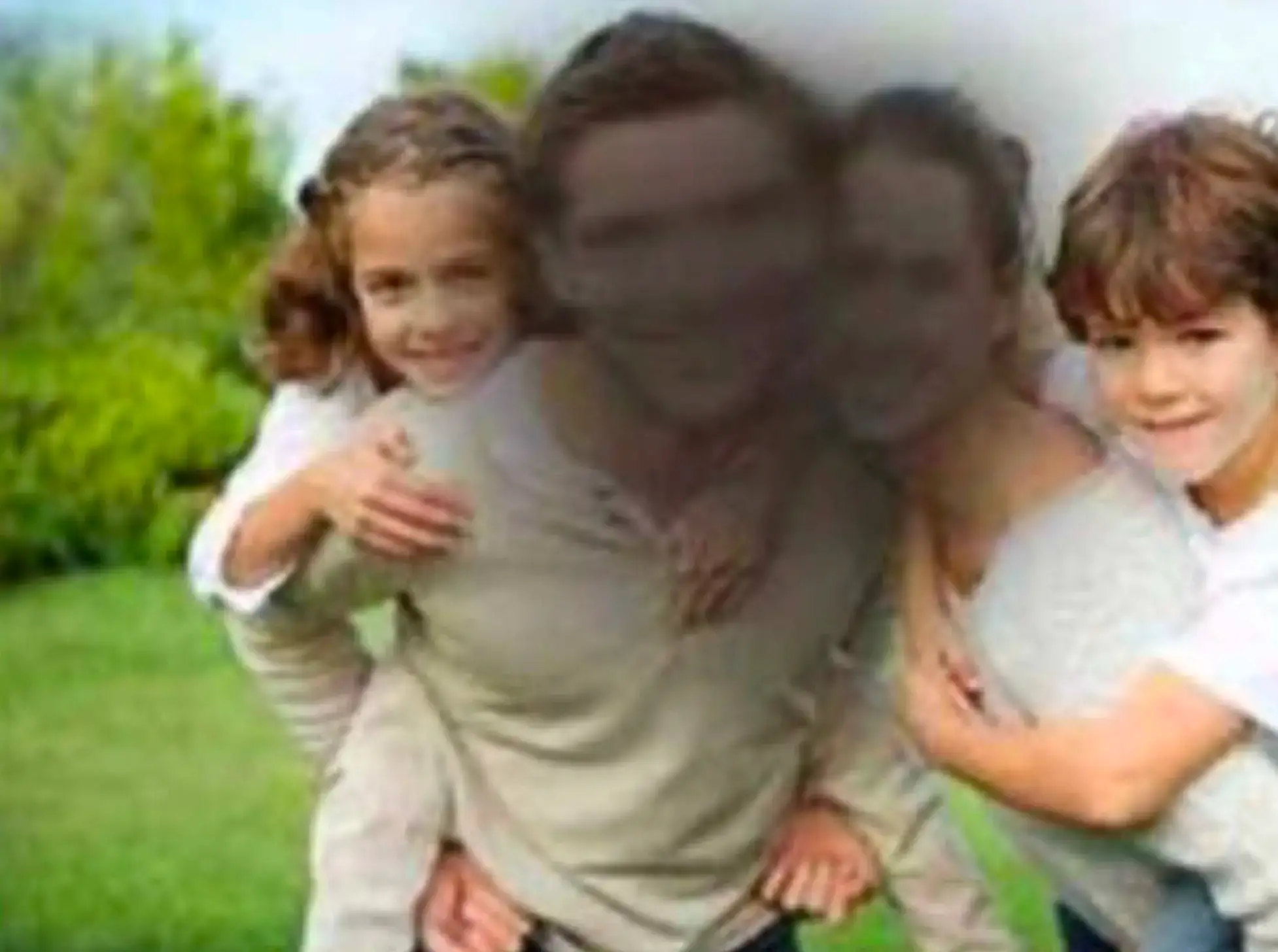 Simulation of blurred central vision caused by a macular condition, showing a family outdoors with the centre of the image obscured while the edges remain clearer.